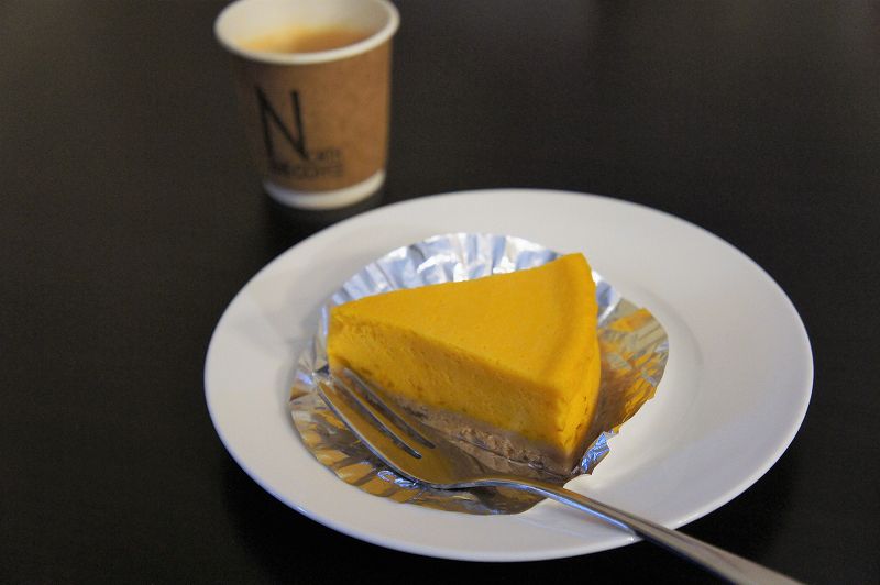 かぼちゃのチーズケーキとコーヒーがテーブルに置かれている