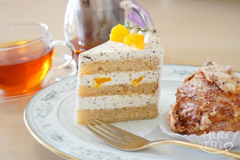 「ハレとケ洋菓子店」のケーキとシュークリームと紅茶がテーブルに置かれている
