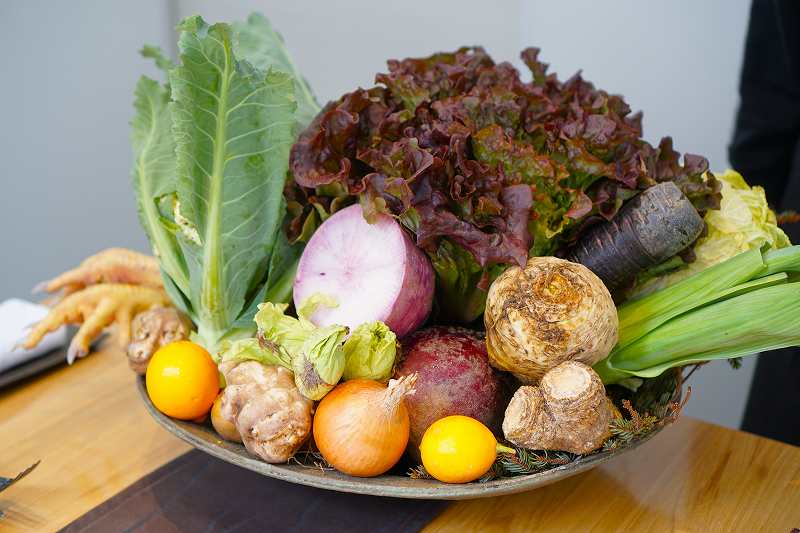 野菜や果物が大きな皿にのせられ、テーブルに置かれている