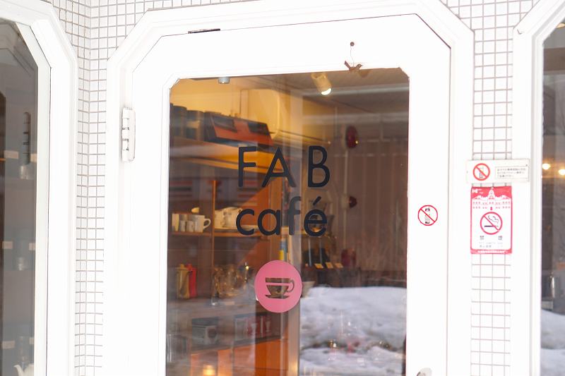 白を基調とした「FABcafe」の入口ドア外観