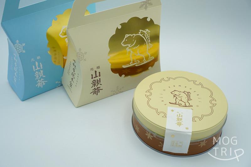 函館「千秋庵総本家」の看板商品 山親爺の箱入りと缶入りがテーブルに置かれている