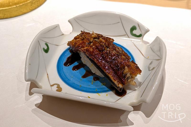 札幌すすきのにある「まる鮨」の穴子の握りがテーブルに置かれている